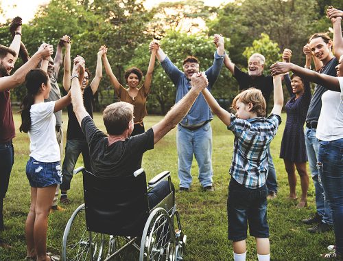 Group of people holding hand together in the park
